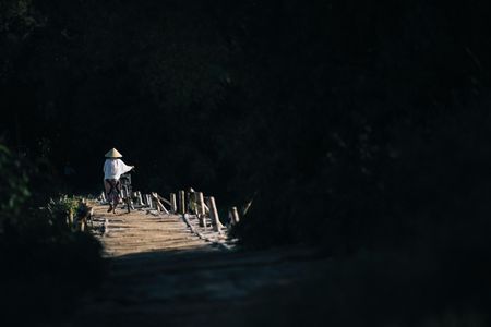 Locals cross a small wooden foot bridge in Quang Ngai Province in central Vietnam, just downriver from the My Lai Massacre in 1968.