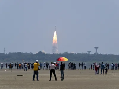 Onlookers watch as a rocket carrying the Aditya-L1 spacecraft launches. The mission will study the sun&#39;s outer layers and the influence of solar activity on the solar system.