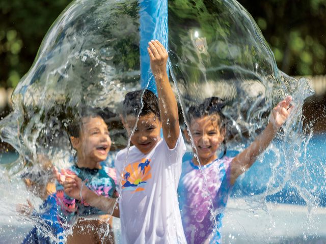 Kids cool down at an animal-themed splash pad at Zoo Miami. Mist stations also help visitors avoid overheating on sweltering days.