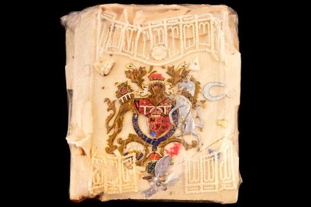 This slice of marzipan was likely cut from the top or side of a single-tier cake sent to Clarence House for the enjoyment of the queen mother's staff.