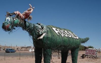 One of the sad dinosaurs at Stewart's Petrified Wood near Petrified Forest National Park in Arizona.