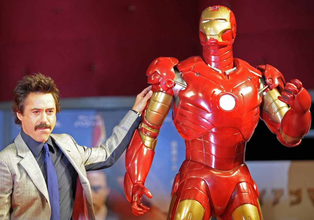 US actor Robert Downey Jr. poses by a life-size Iron Man model