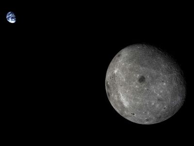 A view of the Earth-Moon system from the Chang’E 5 Test mission.  The large dark area near the center of the Moon’s far side is Mare Moscoviense.