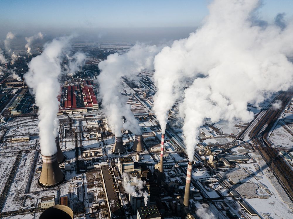 Smoke stacks of a coal fired power plant in China during winter