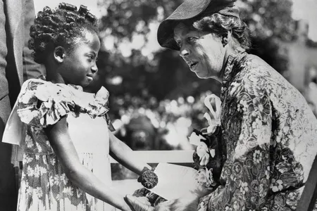 Eleanor Roosevelt talks to a child at the ceremonies inaugurating the slum clearance in Detroit, Michigan.