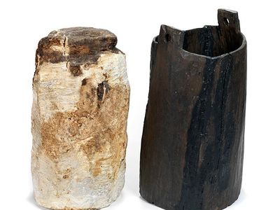 A 2,325-year-old bog butter weighing almost 30 pounds,  alongside the keg it was found in. 
