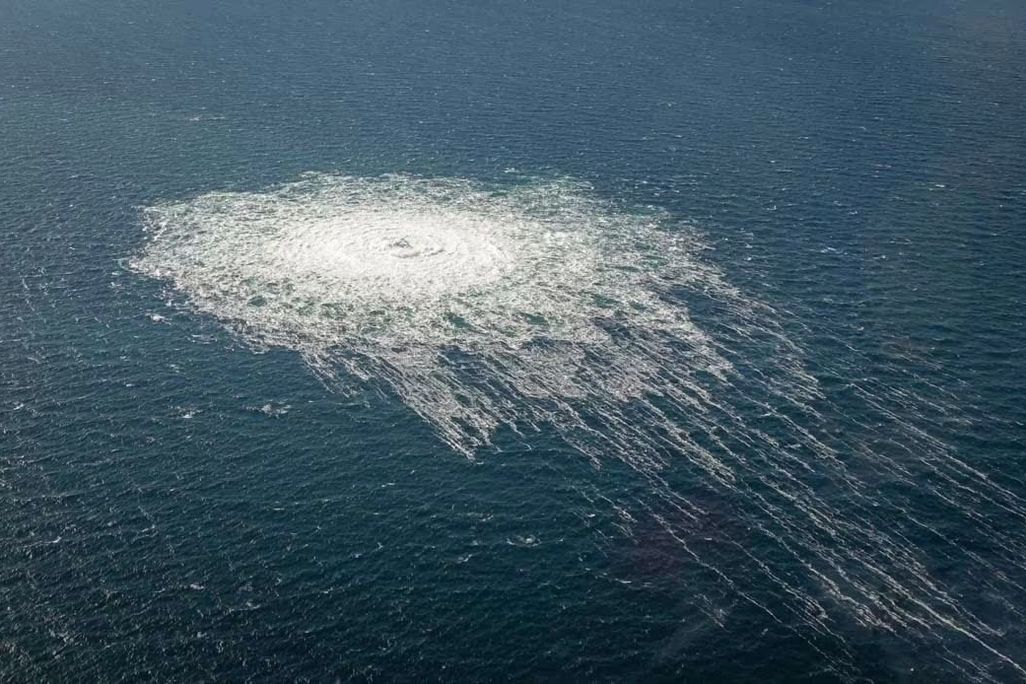 Methane gas bubbles up to the surface of the ocean from burst pipes in the Baltic Sea