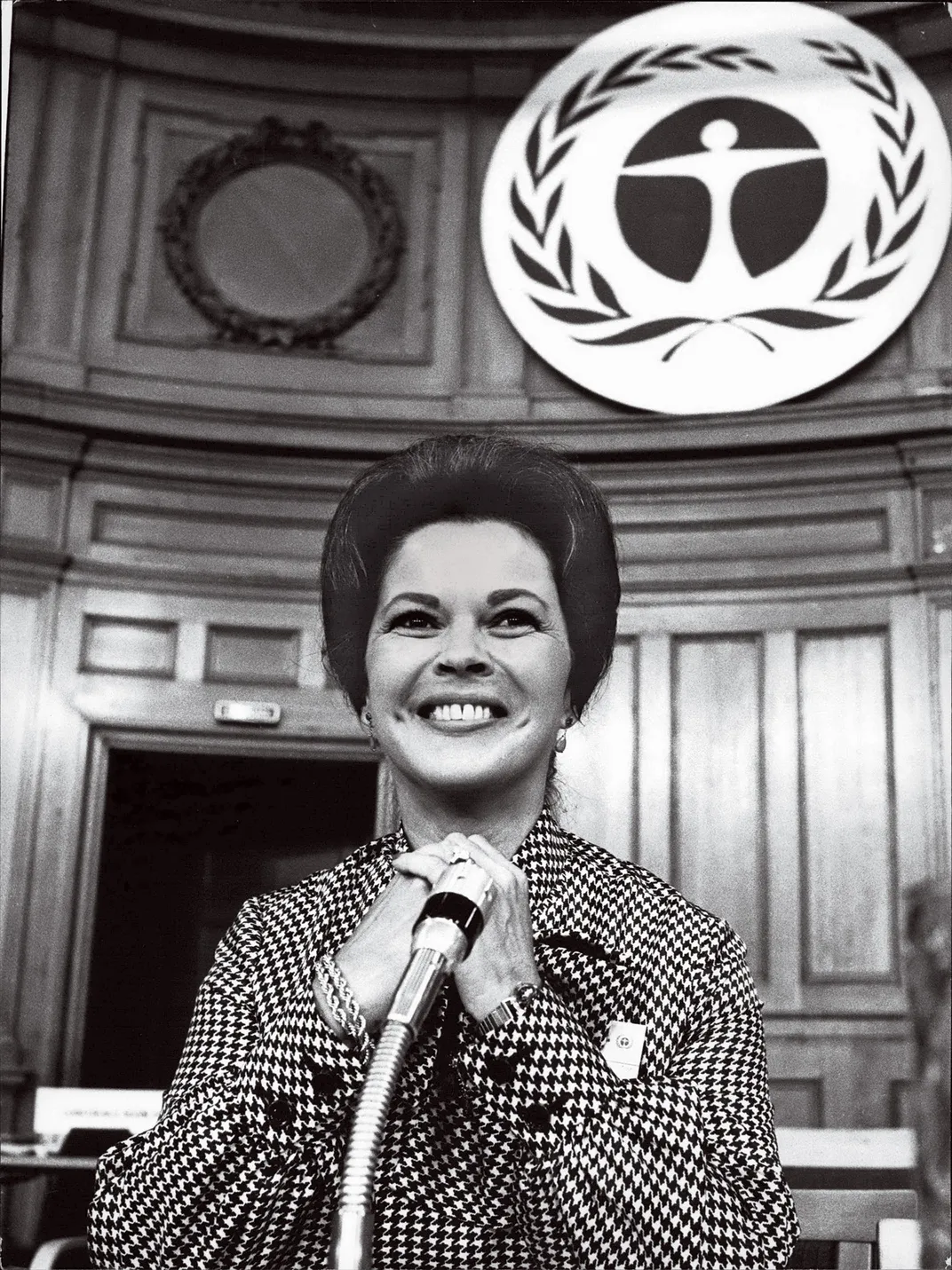 Shirley Temple Black at a microphone