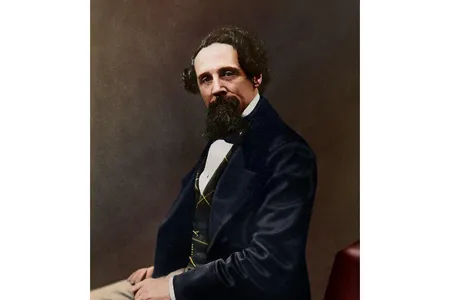 The colorized photograph shows 47-year-old Dickens in a blue, green and yellow waistcoat; a navy blue jacket; and tan trousers.