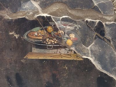 A recently unearthed fresco at a house in Pompeii shows a flatbread that could have been a precursor to pizza.