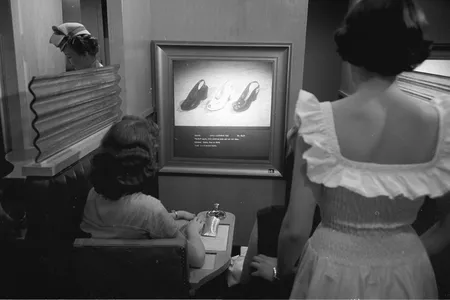 Women compare A.J. Freiman shoes. 