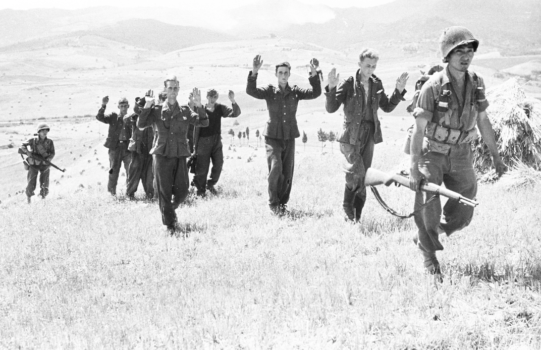 Rudy Tokiwa bringing in captured German soldiers in Italy.