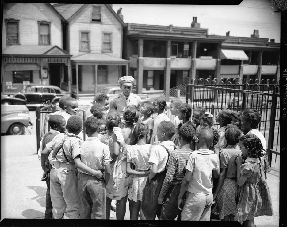 Children gathered around Tuskegee Airman James T. Wiley
