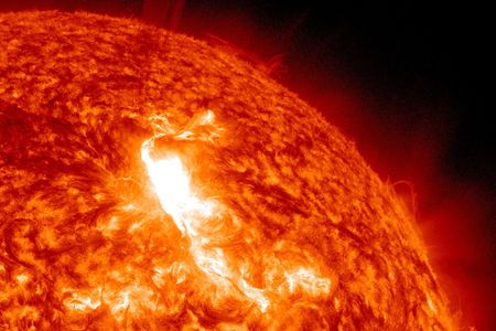 A solar flare erupting from the sun in deep space.