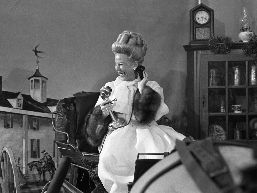 Martha Mitchell with antique telephone