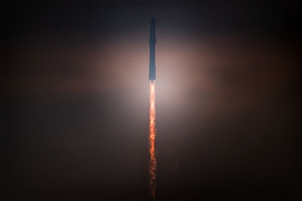 A rocket launches into a dark sky