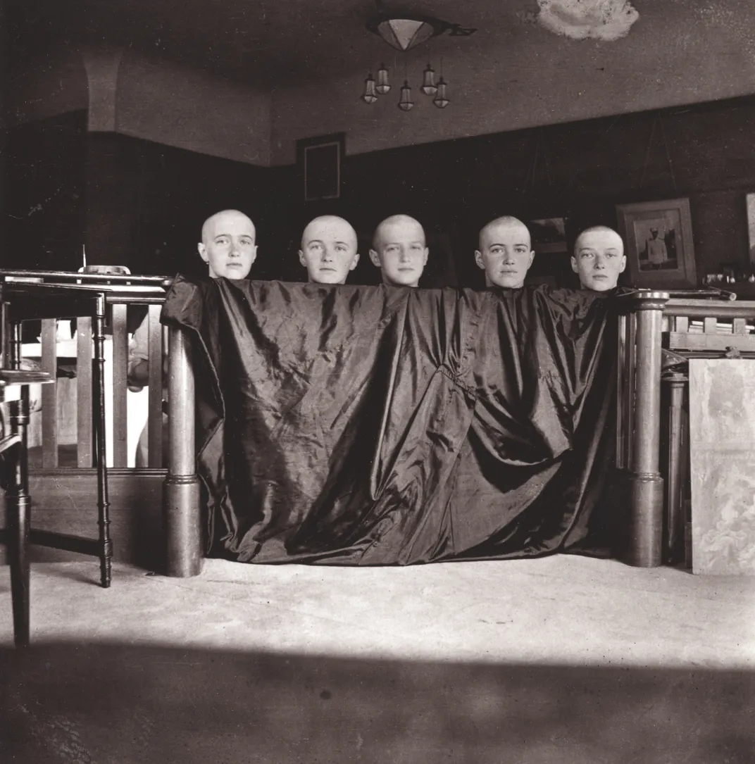 L to R: Anastasia, Olga, Alexei, Maria and Tatiana pose with shaved heads in June 1917.