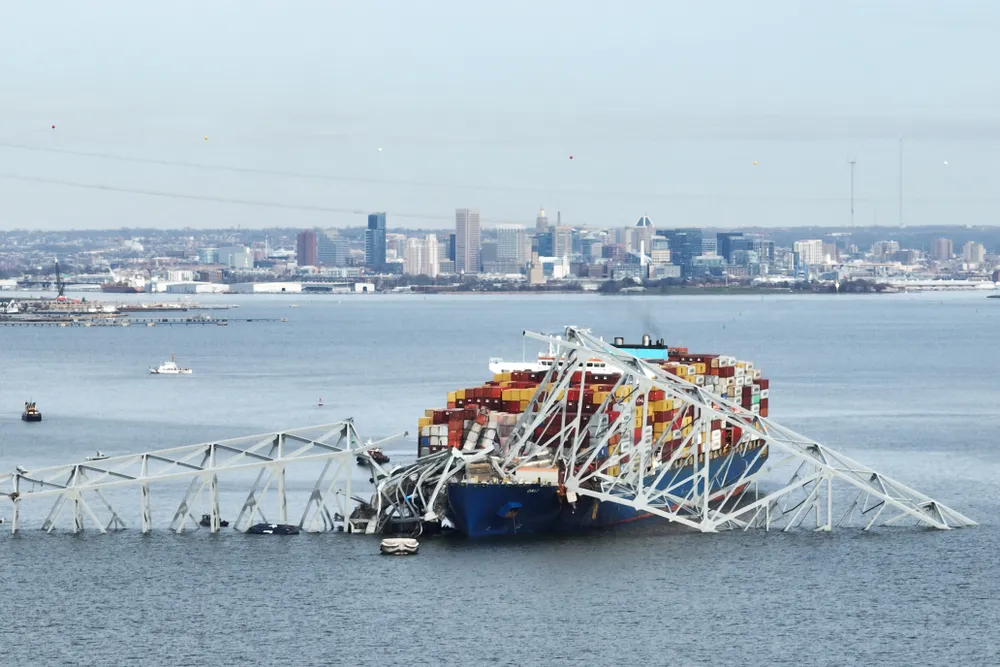 The steel frame of the Francis Scott Key Bridge rests atop of a container ship following the bridge's collapse on March 26, 2024.