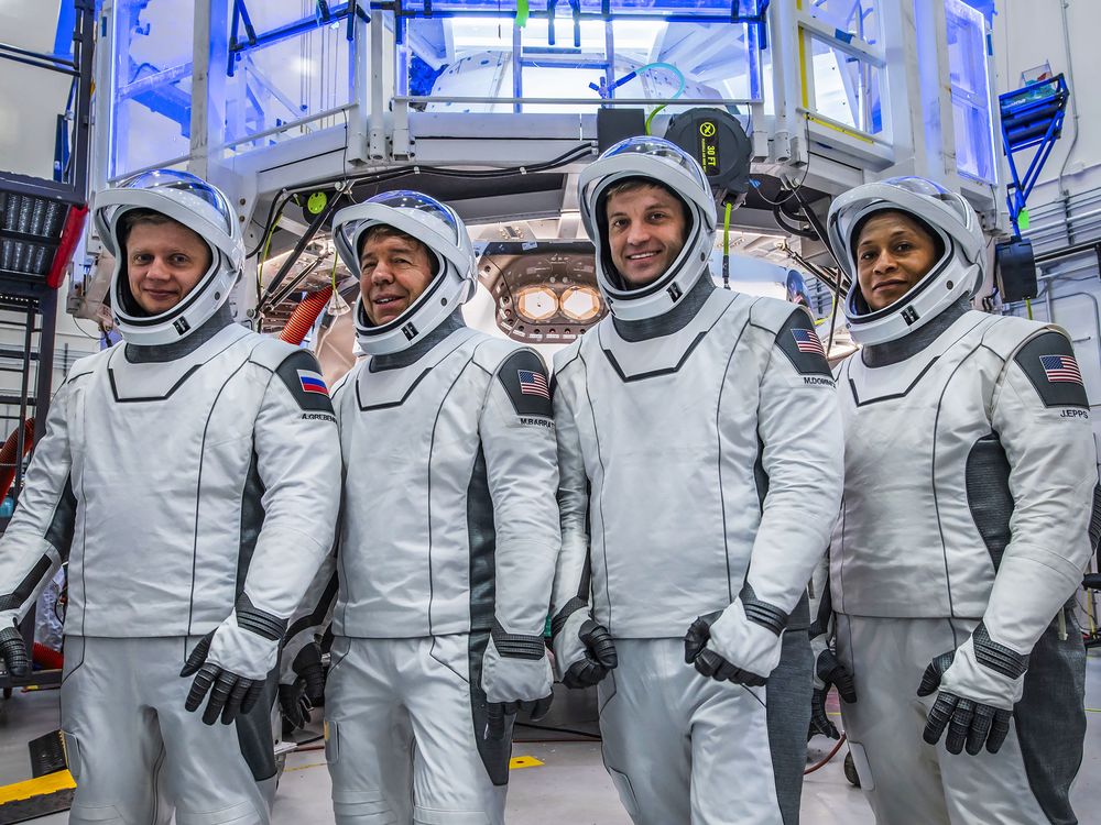 Four astronauts in space suits