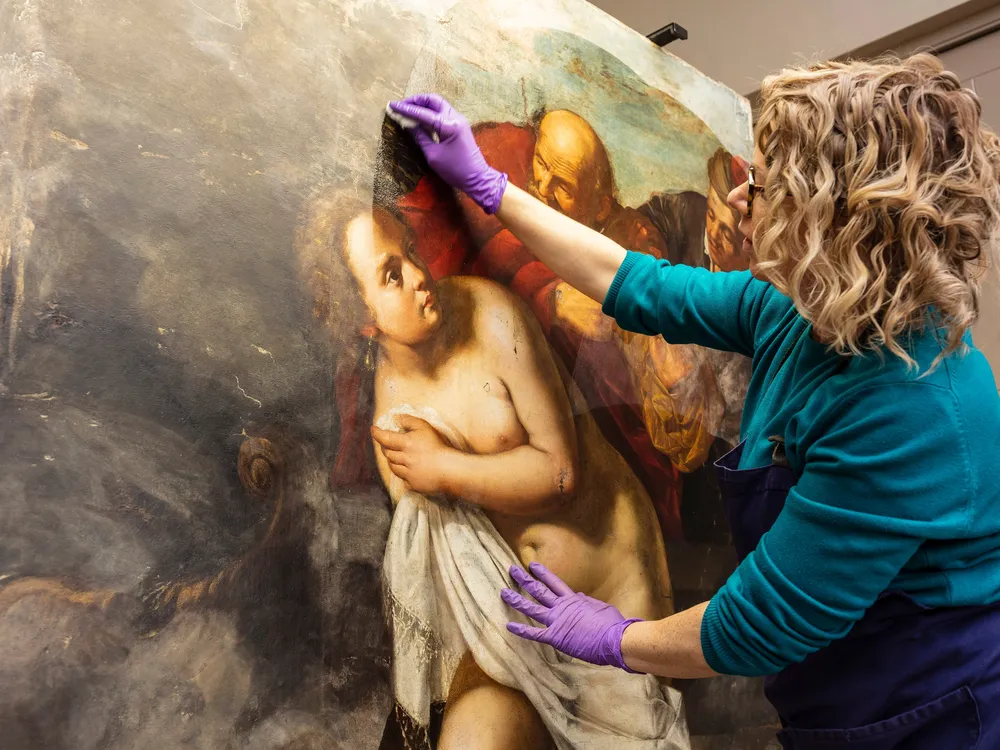 Conservator Adelaide Izat works on Susanna and the Elders​​​​​​​, a painting newly reattributed to Artemisia Gentileschi.