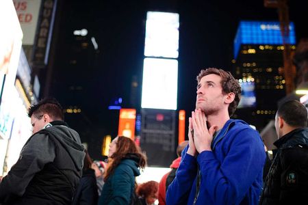 A young man watches incoming presidential election results in 2016 on the giant screens of Times Square.