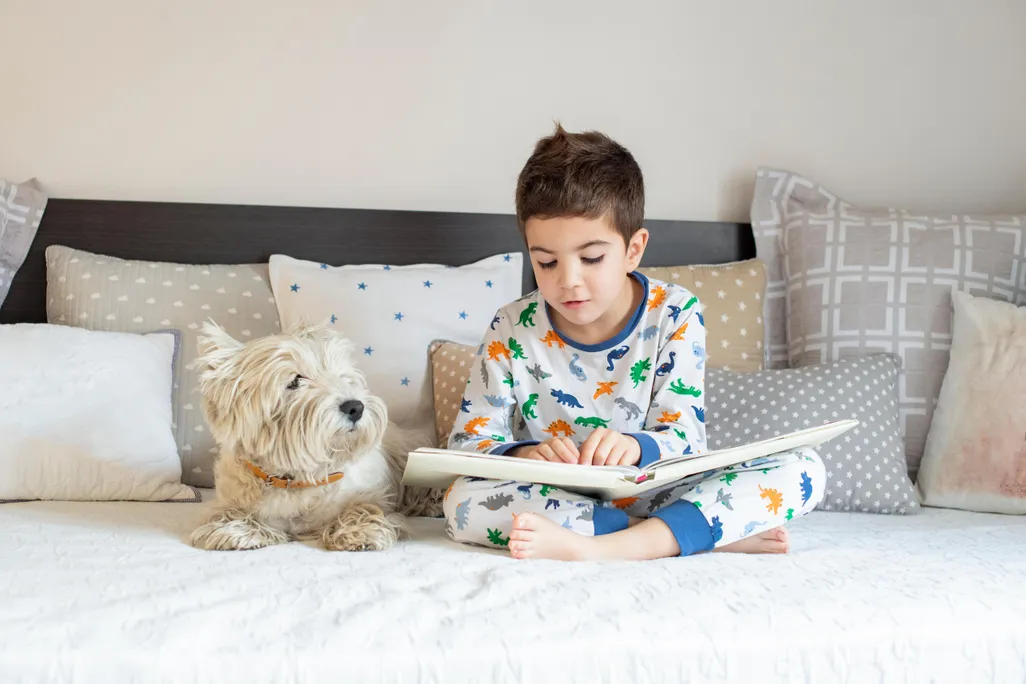 Boy reading with his dog