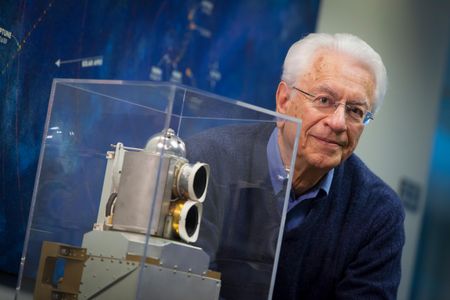 Dr. Tom Krimigis with a flight spare of the Low-Energy Charged Particle detector currently flying on the Voyager 1 and Voyager 2 spacecraft.