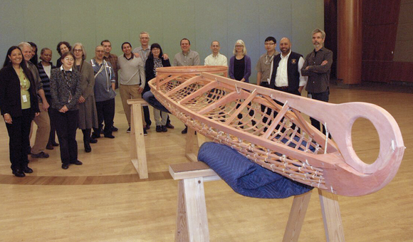 Members of the staff of the National Museum of the American Indian in New York hold a welcoming ceremony for a kayak frame built in the traditional Yup'ik way at the Qayanek Qayak Preservation Center in Kwigillingok, Alaska. A testament to the ingenuity and innovation of the Native cultures of the Arctic, the kayak frame will become a teaching exhibit when the New York museum's imagiNATIONS Activity Center opens this May. (National Museum of the American Indian, Smithsonian)