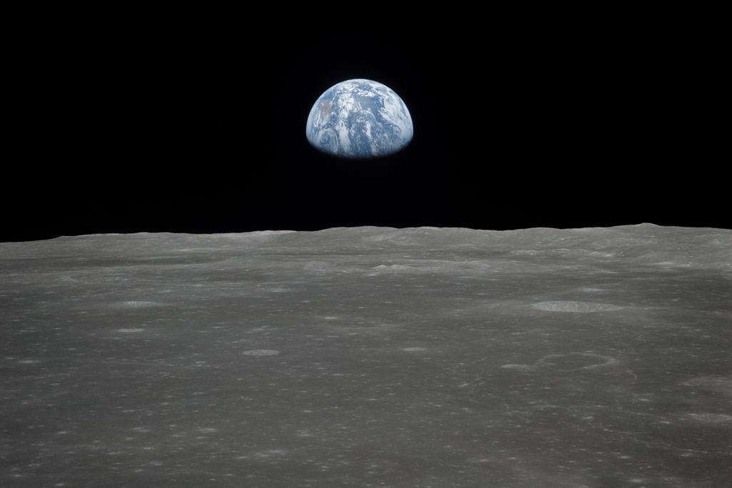 View of Earth rising over Moon's horizon taken from Apollo 11 spacecraft