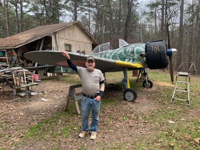 U.S. Army veteran Zeb Harrington stands with his nearly complete Japanese Oscar. The prop spinner was once a stainless-steel mixing bowl. What will he build next? “I always thought a Spitfire was a beautiful plane,” he says.