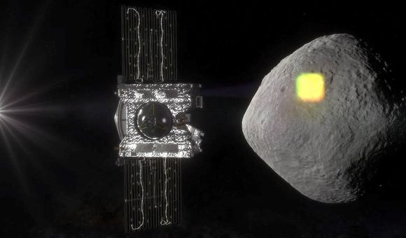 Bennu is shaped like a three-dimensional diamond and seemingly smooth from far away. OSIRIS-REx is in the foreground of this artist’s replication. The spacecraft will gather a sample from Bennu next week. (NASA/Goddard/University of Arizona)
