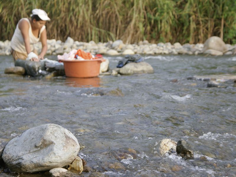 Woman washing clothes in the Babahoyo River. Smithsonian Photo
