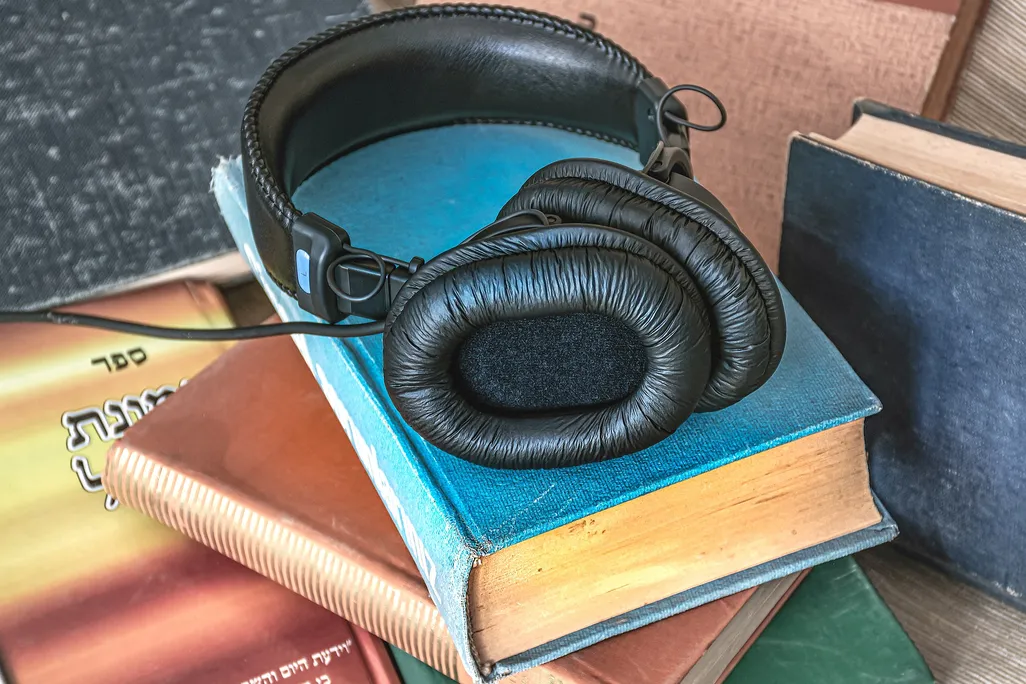 Set of headphones on a stack of books