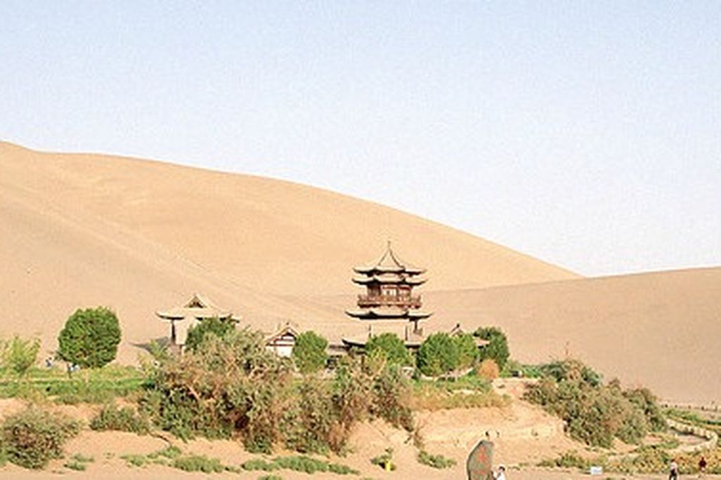 Tourists explore the Crescent Moon Spring along the historic Silk Road trade route.