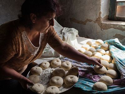 Rima Timbaryan collects dough for baking.