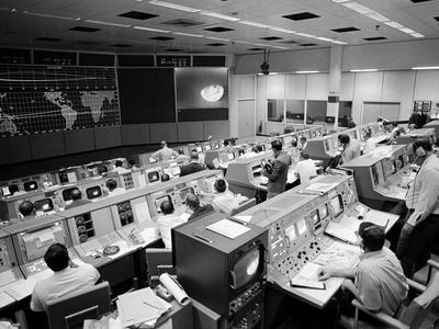 The Apollo 8 mission controllers waited on Christmas Eve, 1968, as humans flew around the moon for the first time. Courtesy University of Nebraska Press.