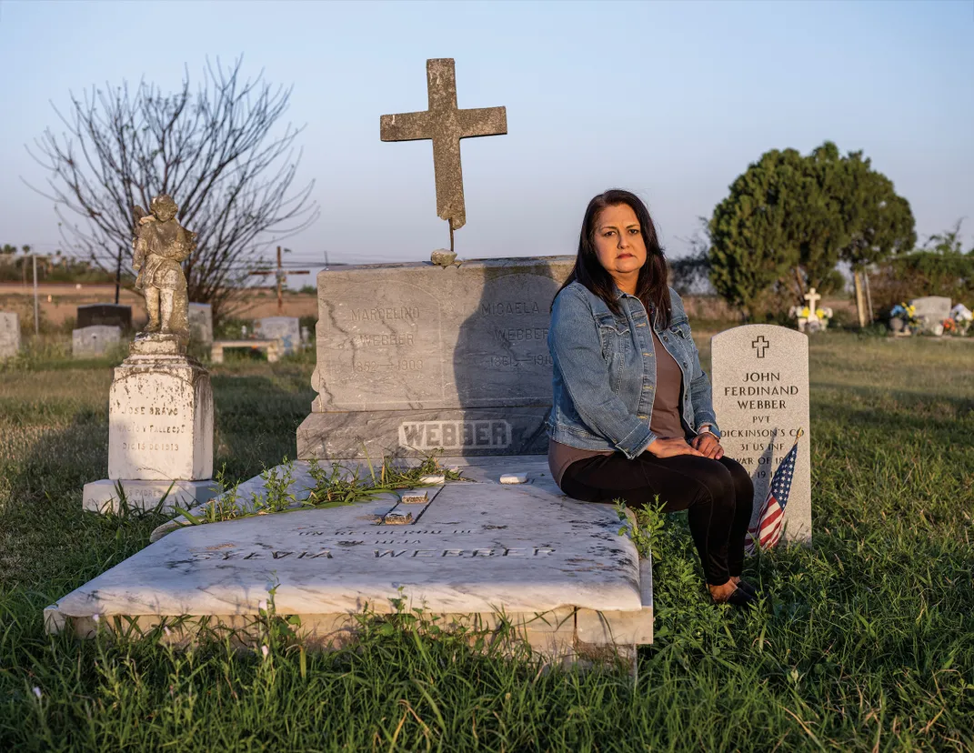 a women sits in a cemetery