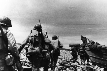 American assault troops move up the beachhead from their landing craft in northern France.