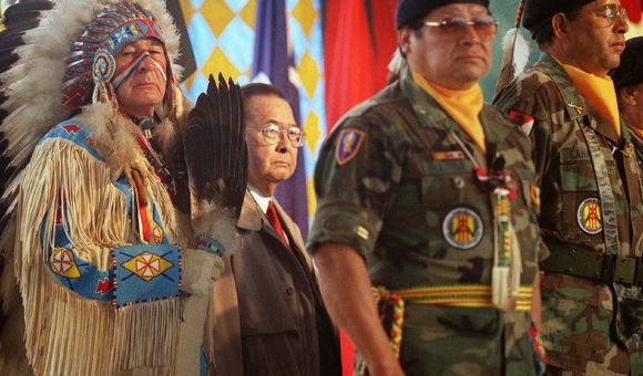 Dressed in ceremonial regalia, Senator Ben Nighthorse Campbell (Northern Cheyenne), a veteran of the Korean War, stands with World War II veteran Senator Daniel K. Inouye  and Native American veterans  of the Vietnam War during the opening of the National Museum of the American Indian on the National Mall.  September 21, 2004, Washington, D.C. (Mario Tama/ AFP for the National Museum of the American Indian, Smithsonian)