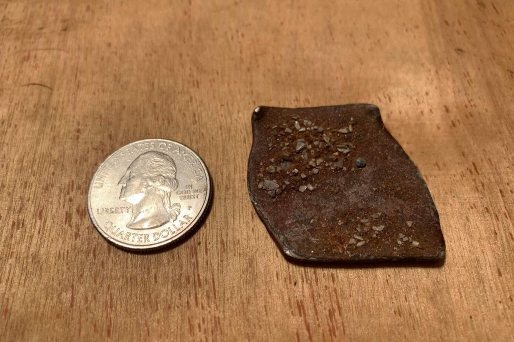 Shipwreck coin next to quarter