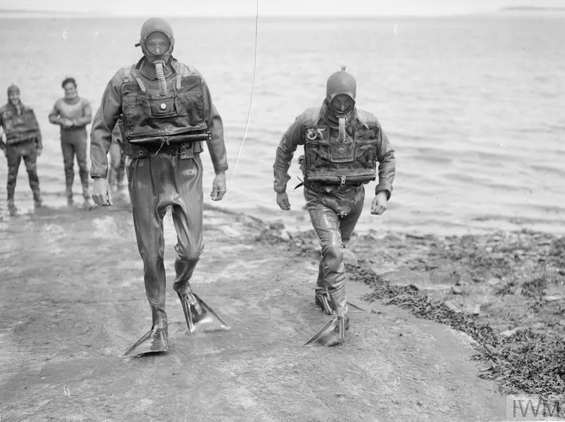 Frogmen of the LCOCU leave the water after completing their task.