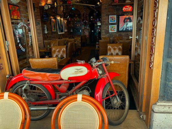 Classic red moto in a classic Roman steakhouse thumbnail