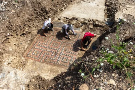 Salvage archaeologists clean the mosaic floor&#39;s elaborate centerpiece.
