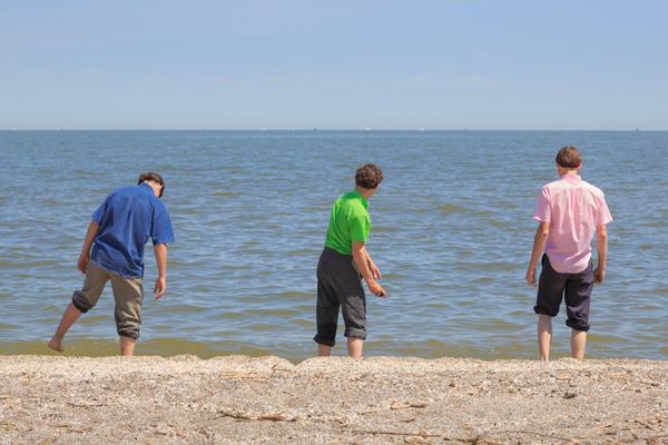 Amish Teen Boys in Traditional Clothing at Lake Erie in Spring thumbnail