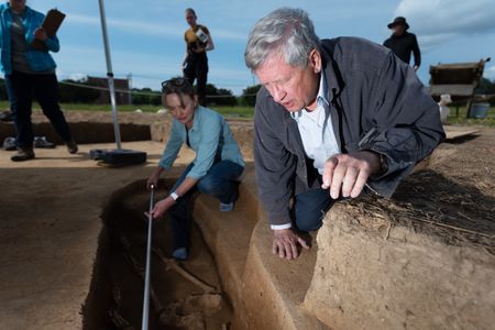 Kari Bruwelheide (background) and Douglas Owsley (foreground) of the Smithsonian's National Museum of Natural History take measurements of the remains of the 17th-century skeleton.&nbsp;
