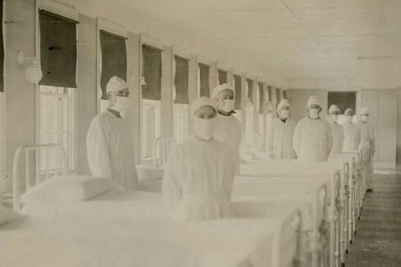 Corpsmen in cap and gown ready to attend patients in influenza ward of US Naval Hospital in Mare Island, California, December 10, 1918.