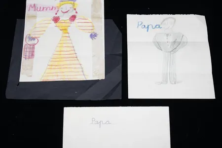 Portraits by a young Charles show his mother, Elizabeth II, wearing a striped dress and tiara, and his father, Prince Philip, wearing a dinner suit and bow tie.