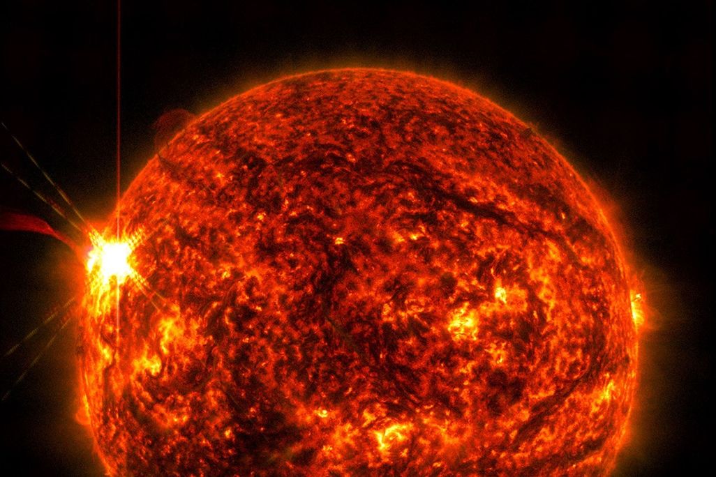 the sun with a burst on its surface on the left