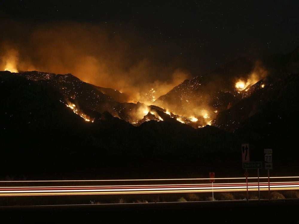 The Bighorn Fire burns through the western side of the Santa Catalina Mountains in Oro Valley, Arizona