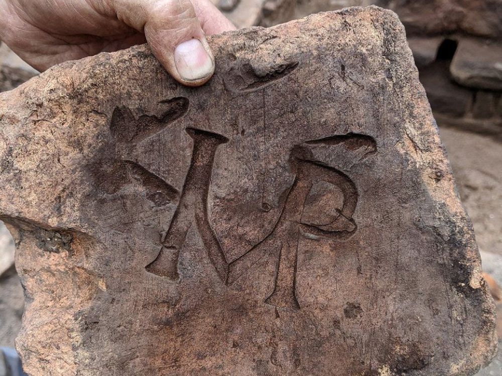 Tile stamped with the letters 'IMP'